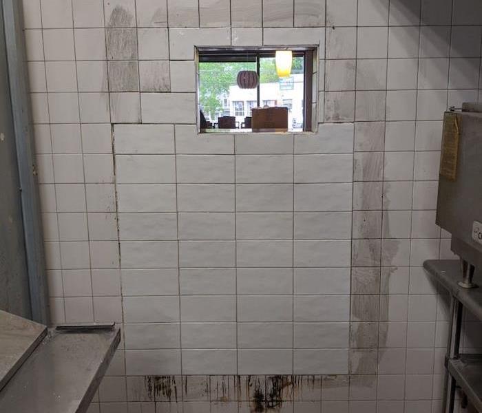 Tile wall with smoke stains in restaurant kitchen
