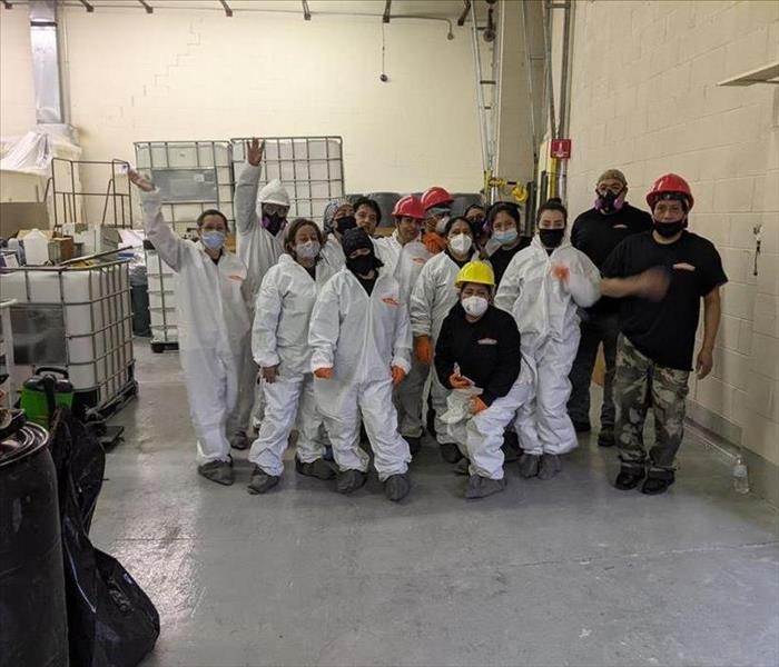 SERVPRO technicians in a group photo wearing PPE