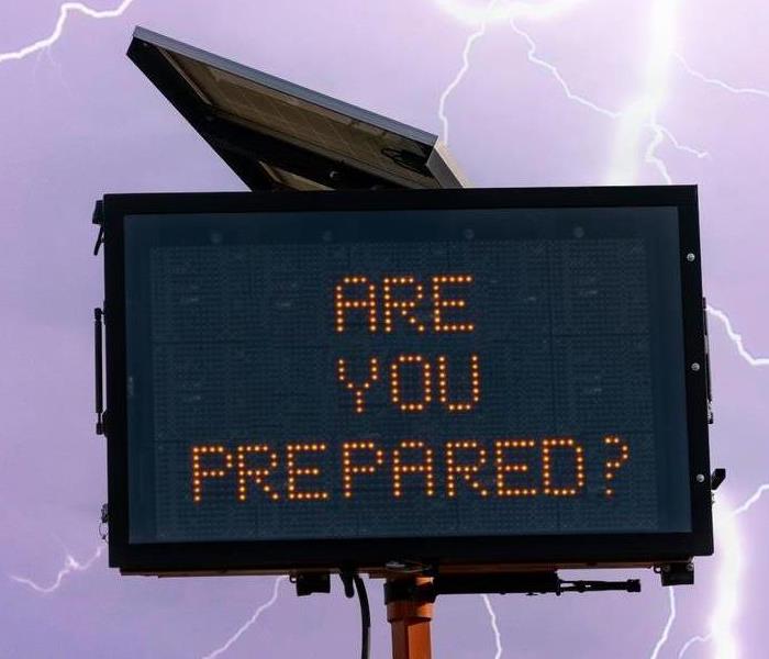 street sign saying "are you prepared" with lightening and cloudy skies in the background