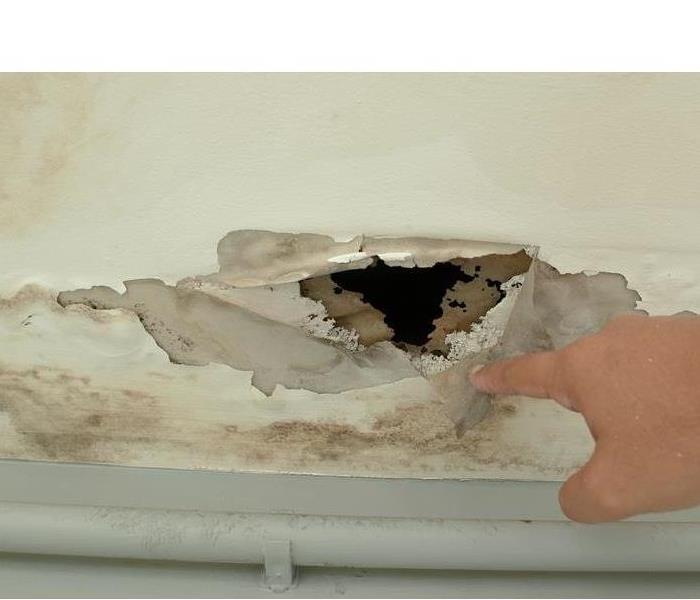 hole in the ceiling from water damage